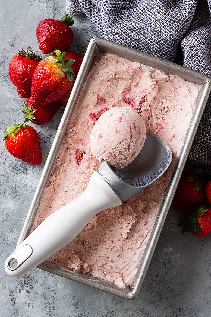 A top down view of no churn ice cream in a pan with a scoop being taken out. 