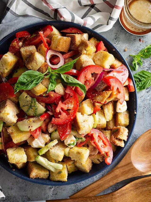 Close up of Panzanella salad garnished with fresh basil.