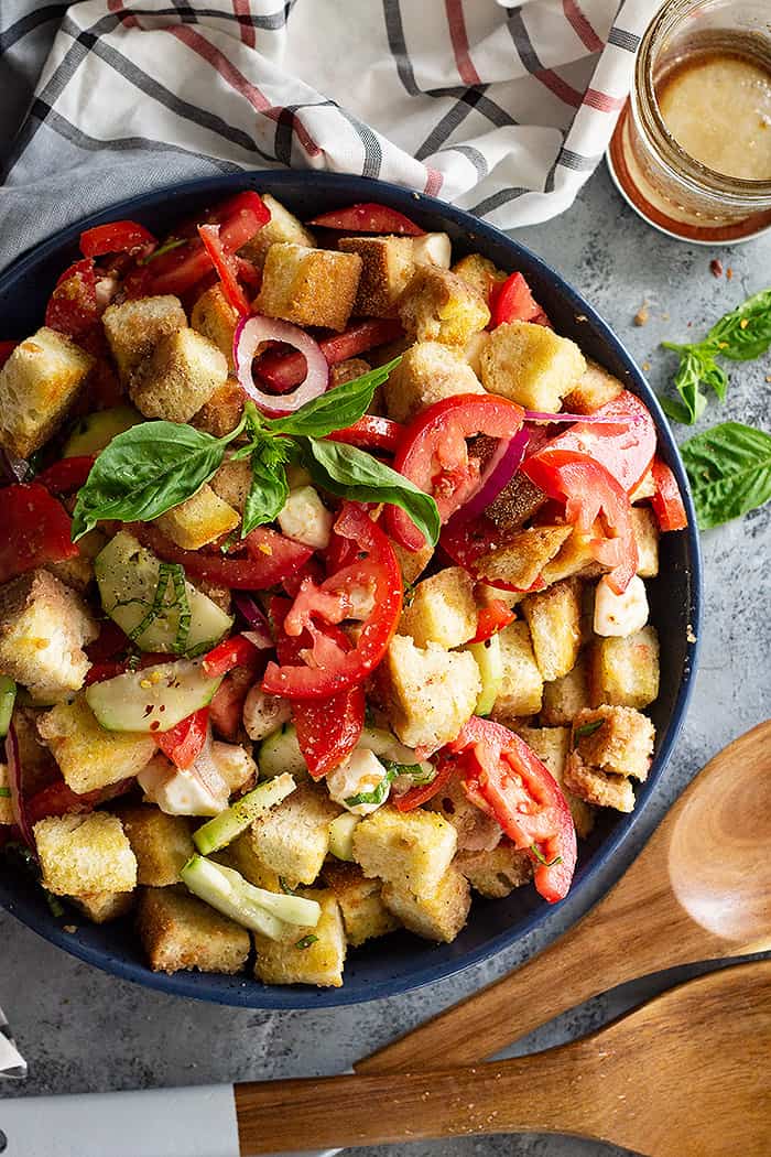 Close up of Panzanella salad garnished with fresh basil. 