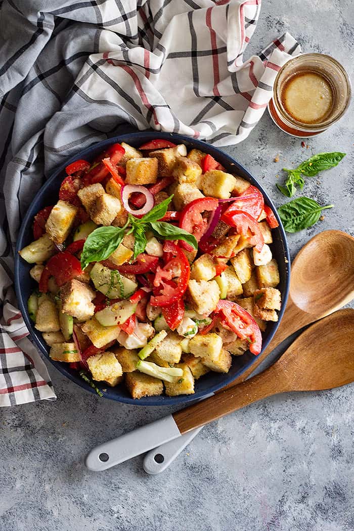 Panzanella Salad with Mozzarella in a large bowl and serving utensils. 
