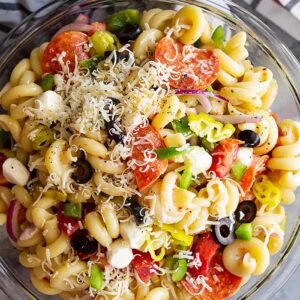 A huge bowl of Pepperoni Pasta Salad topped with Parmesan cheese.