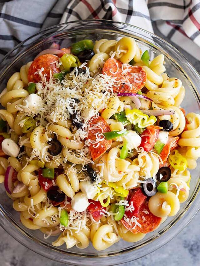 A huge bowl of Pepperoni Pasta Salad topped with Parmesan cheese.