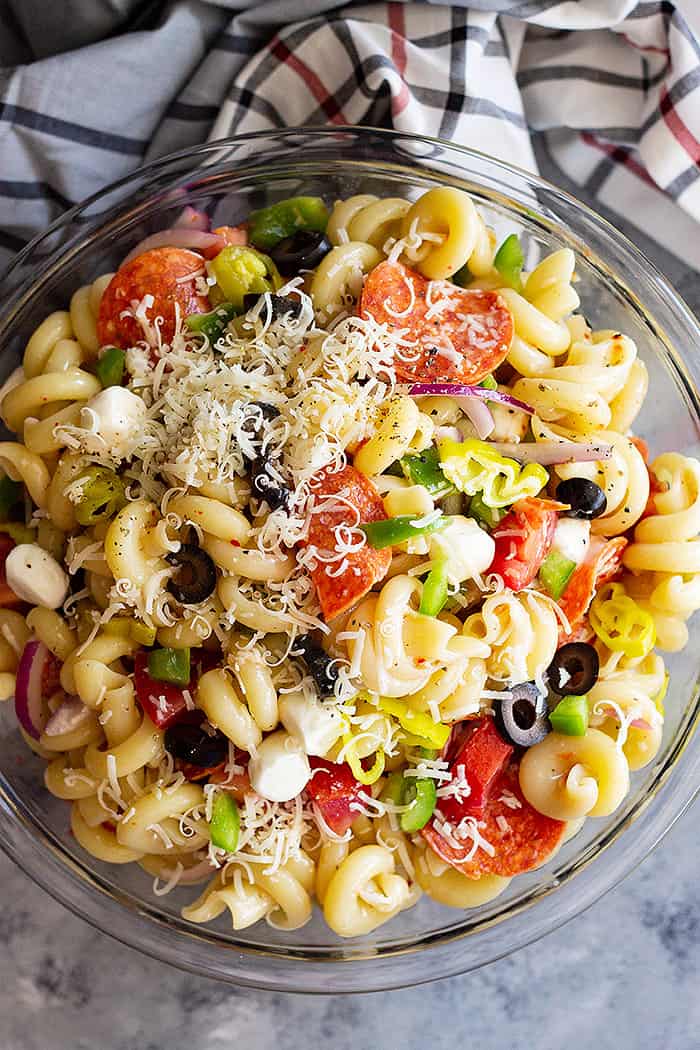 A huge bowl of Pepperoni Pasta Salad topped with Parmesan cheese. 