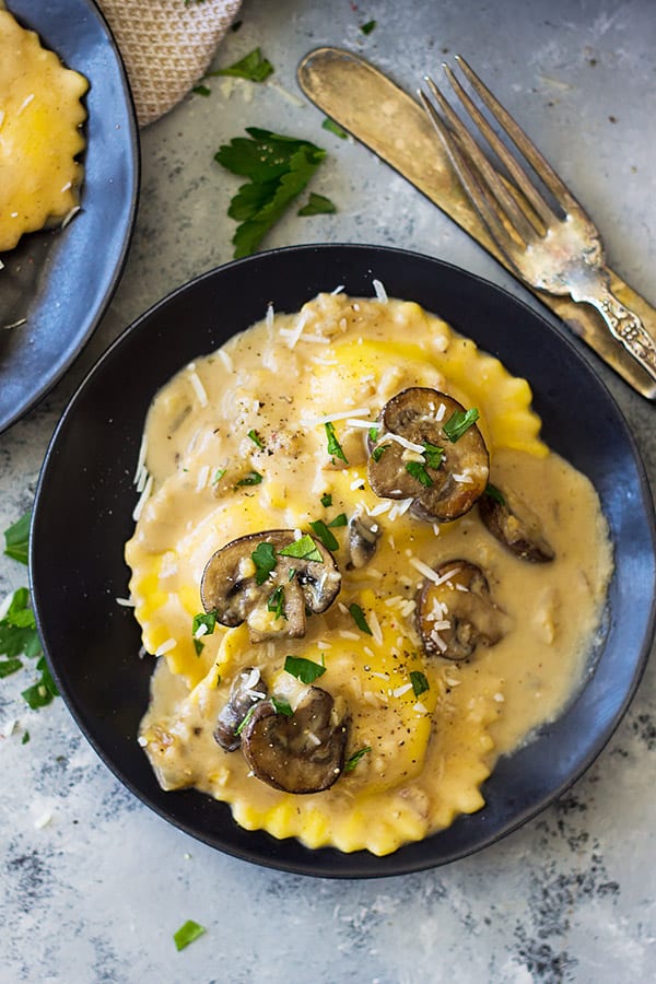 plate with mushroom cream sauce and ravioli