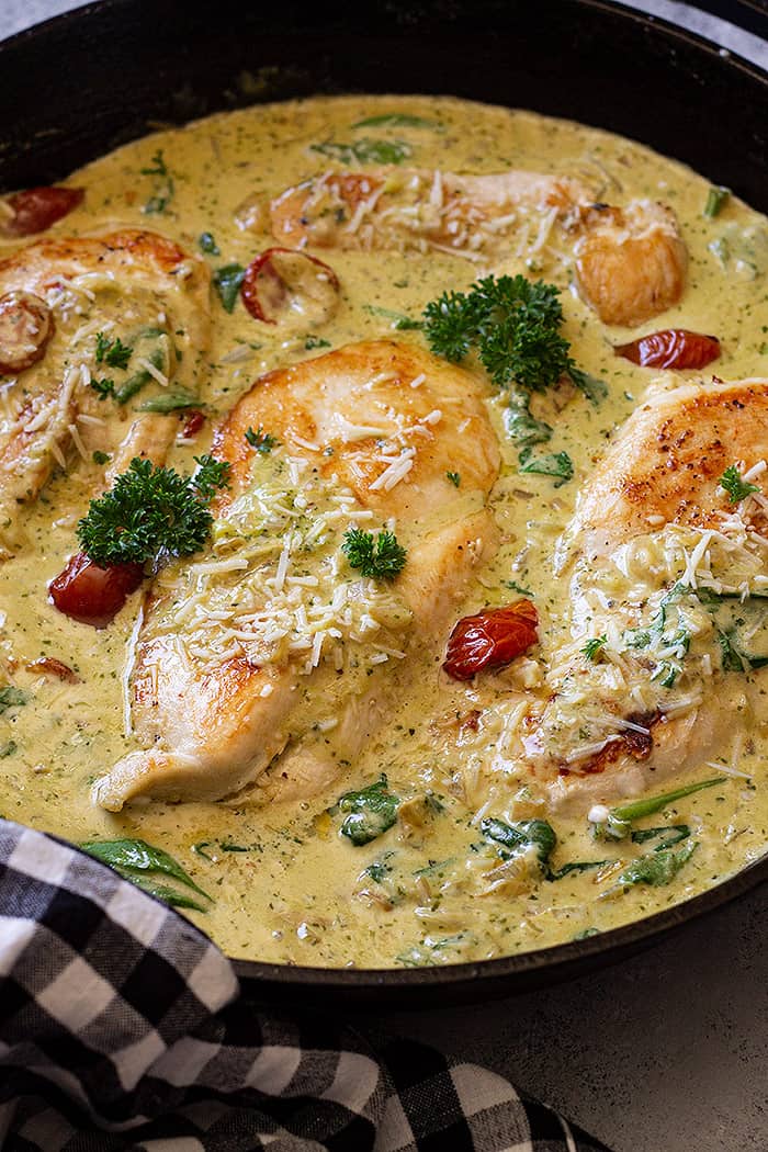 Creamy tuscan chicken in cast iron skillet ready to be served. 