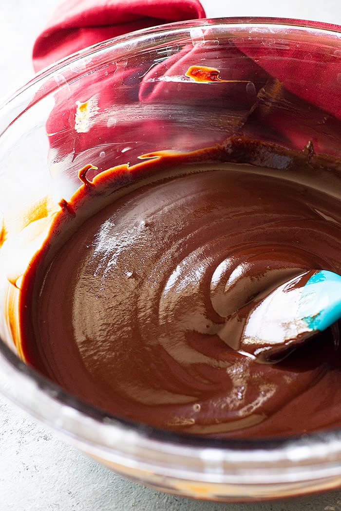 A bowl of smooth and shiny melted chocolate.