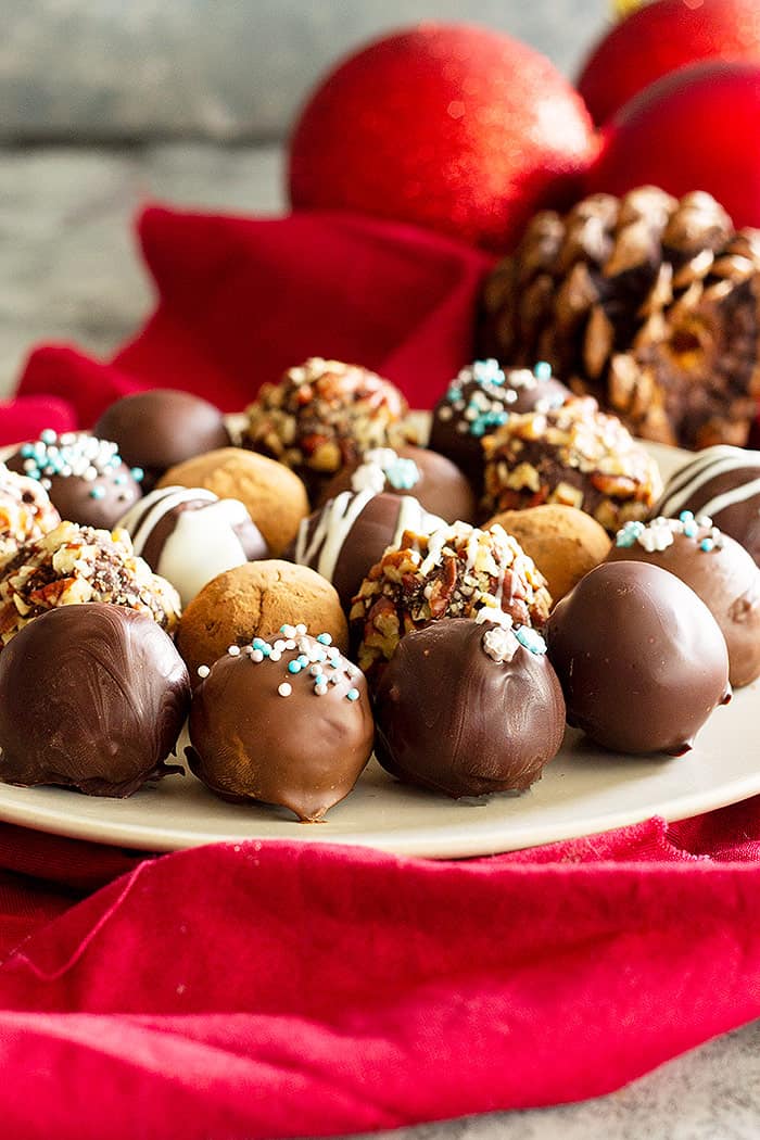 A plate of beautifully decorated homemade chocolate truffles. 