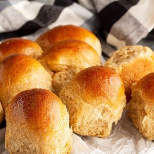 Honey wheat rolls fresh from the oven and lightly brushed with melted butter.