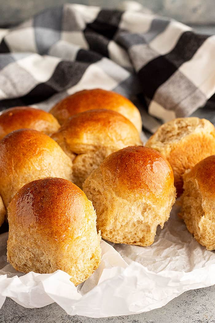 Honey wheat rolls fresh from the oven and lightly brushed with melted butter. 