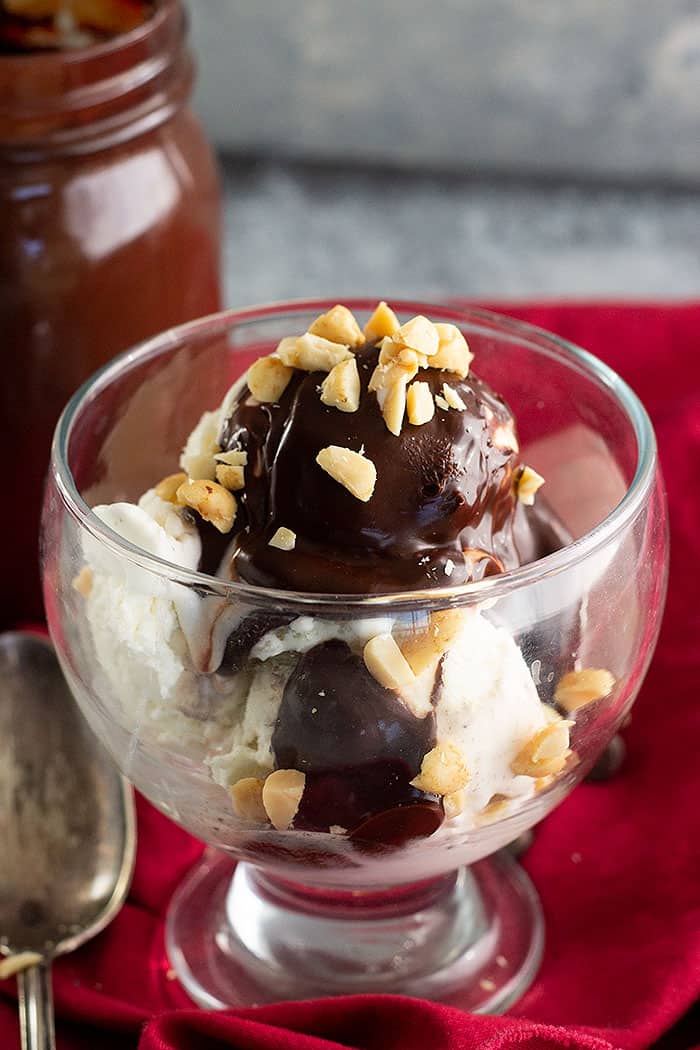 Hot Fudge Sauce poured over ice cream and topped with chopped peanuts. 