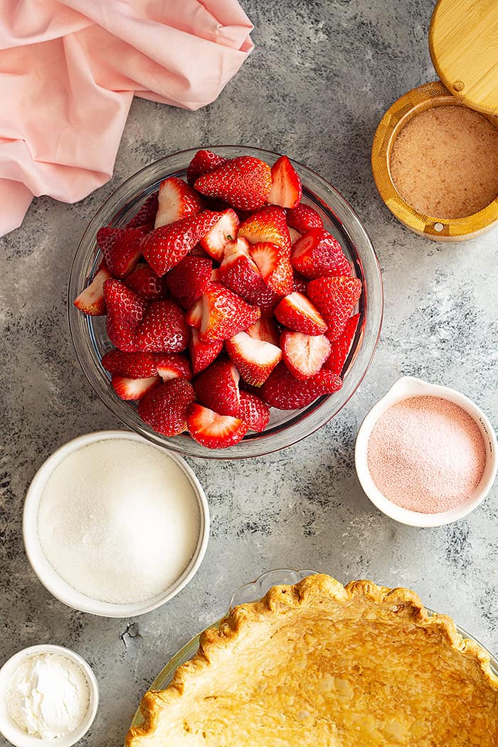 Top down view of prepped ingredients for strawberry pie. 