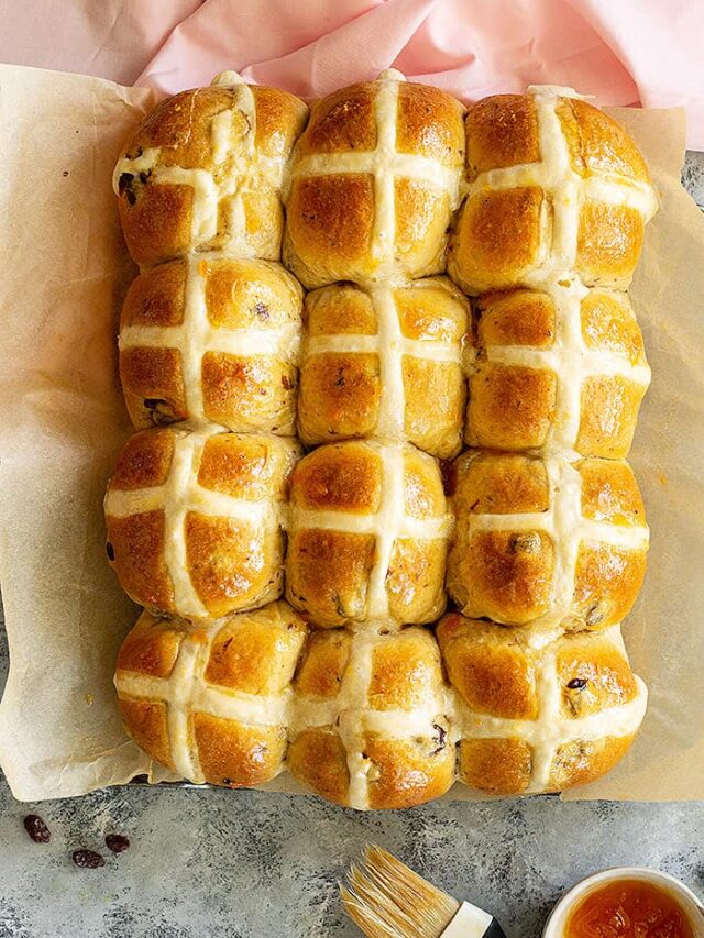 Top down view of a pan of freshly baked hot cross buns.