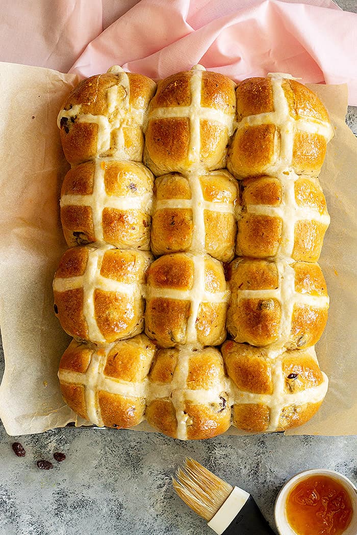 Top down view of a pan of freshly baked hot cross buns. 
