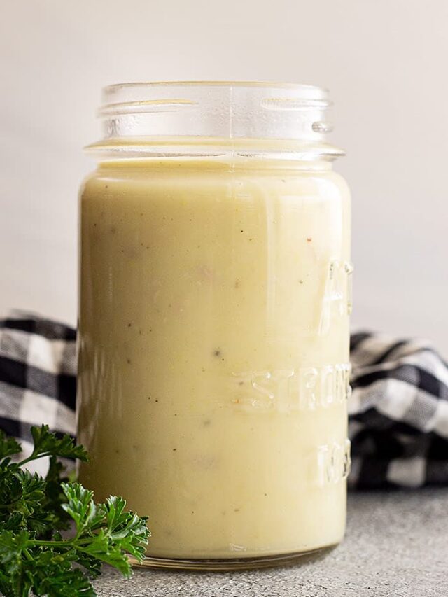 A jar of cream of chicken soup made from scratch. Decorated with a black and white checkered napkin to the side.