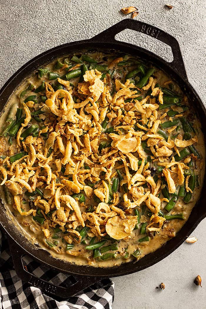 Skillet of Green Bean Casserole with crispy fried onion topping. 