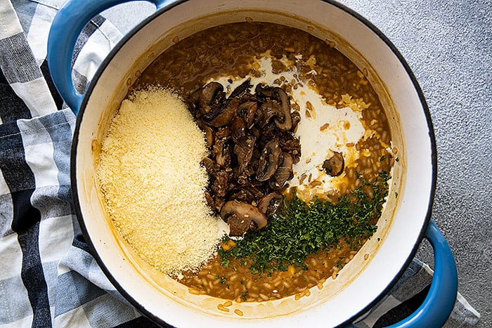 Final step in cooking the risotto is stirring in the mushrooms, parsley, cheese, and cream. 