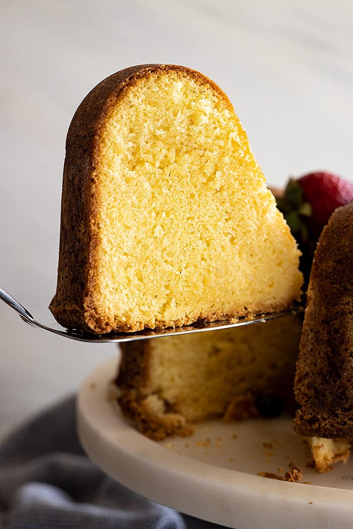 A slice of cake being cut from the cake.