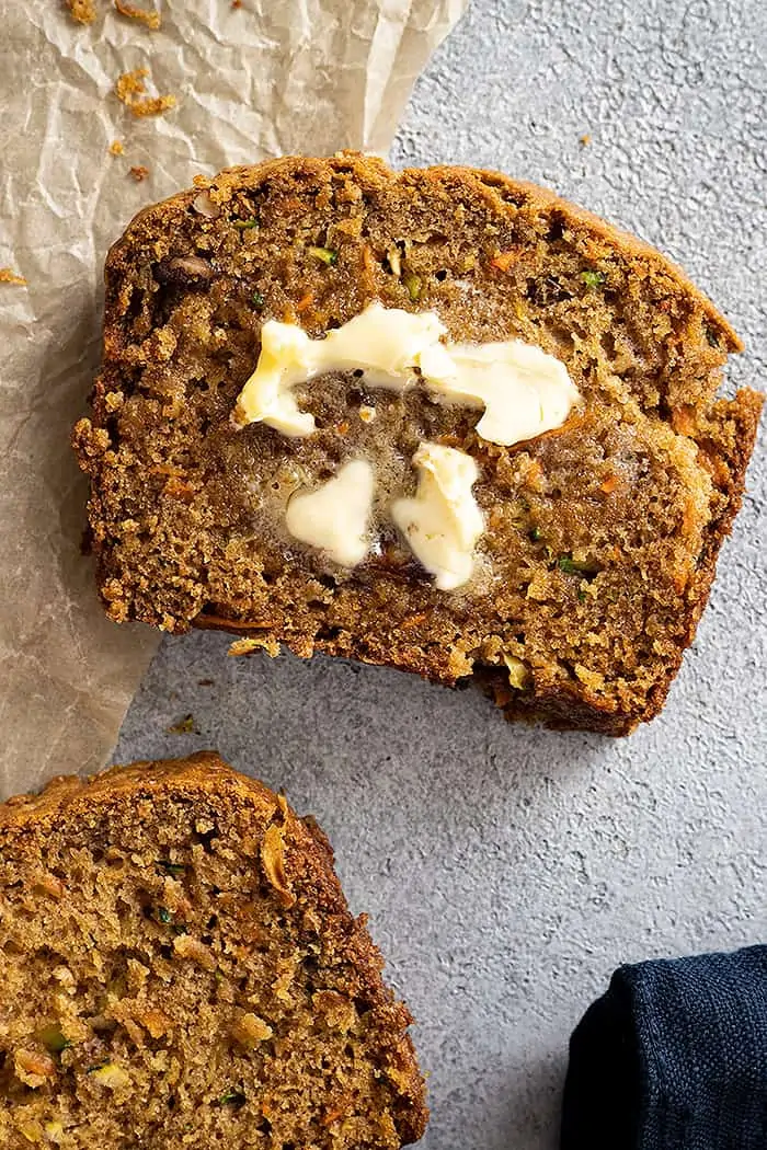 Overhead view of a slice of bread with a pat of butter melting. 