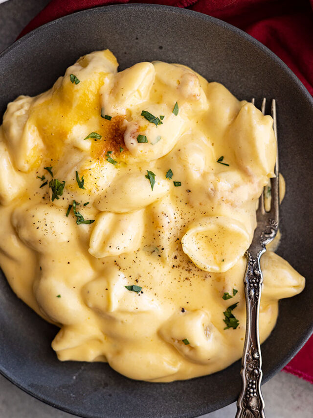 Overhead view of a plate of deliciously indulgent creamy baked mac and cheese.