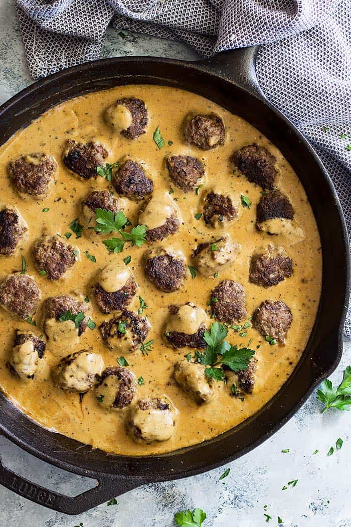 Top down view of Swedish Meatballs in a cast iron skillet. Garnished with parsley.