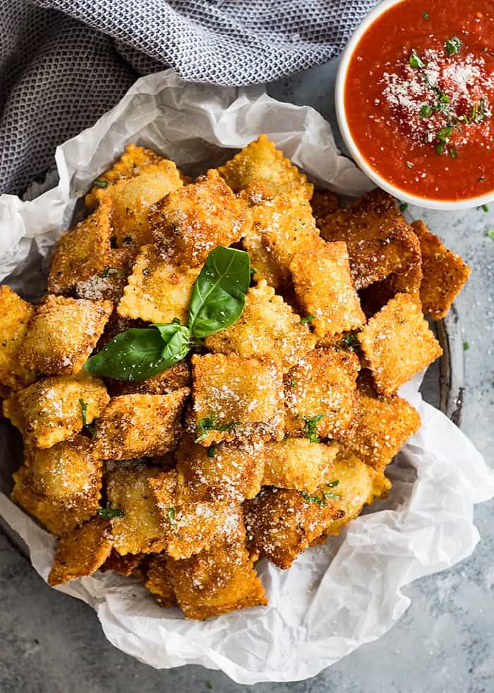 platter with toasted ravioli and bowl with marinara sauce