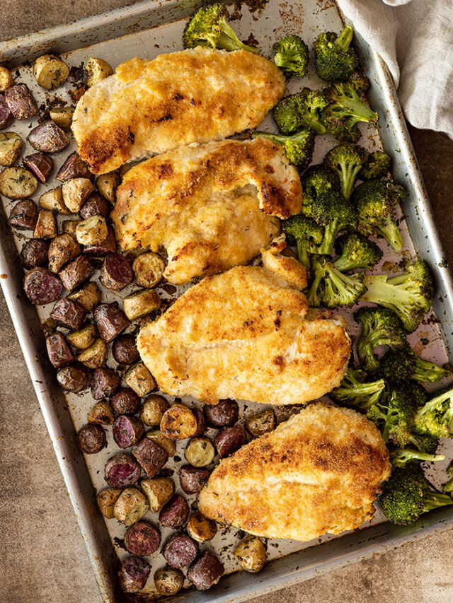 Overhead view of sheet pan dinner fresh from the oven. Tan towel in the corner.