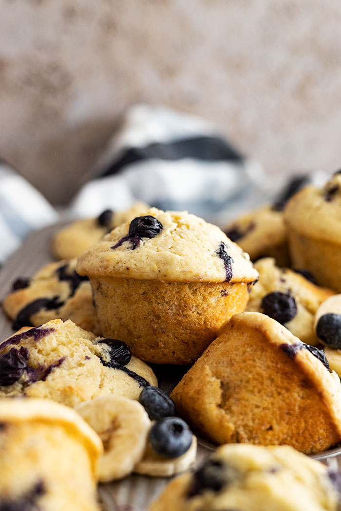 Blueberry banana muffins piled on top of each other.