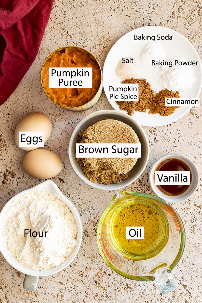 Ingredients to make the pumpkin cake: pumpkin, spices, eggs, brown sugar, vanilla, flour, and oil.