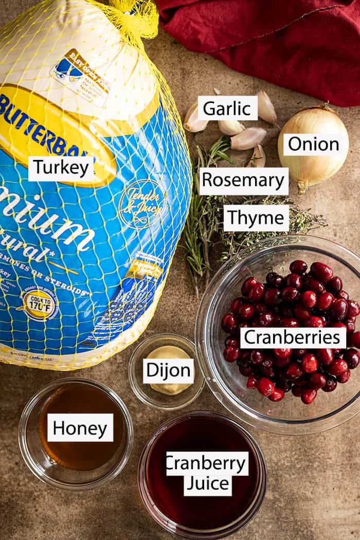 Ingredients to make the turkey: large turkey, garlic, onion, rosemary, thyme, cranberries, dijon mustard, honey, cranberry juice.
