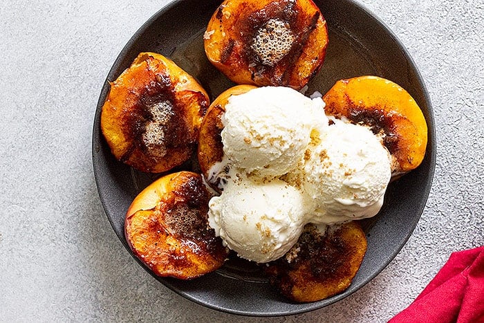 Top down of grilled peaches and ice cream.