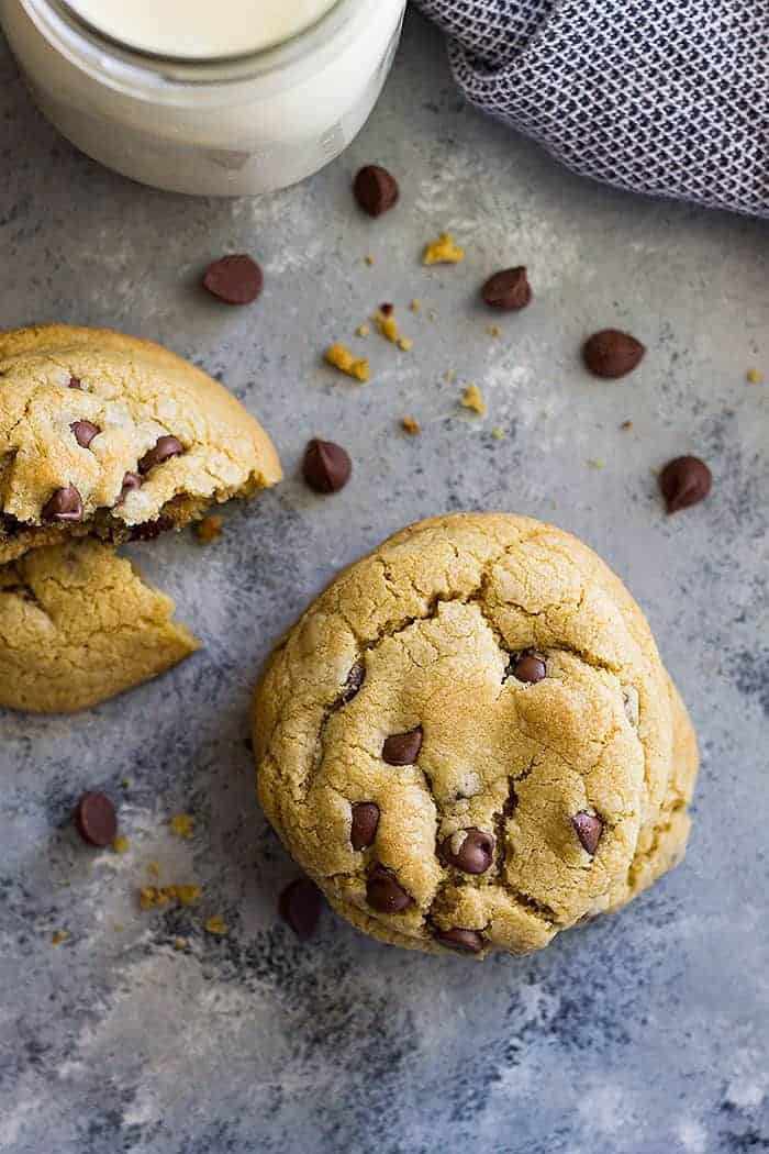 A top down view of no chill chocolate chip cookies and some scattered chocolate chips. 