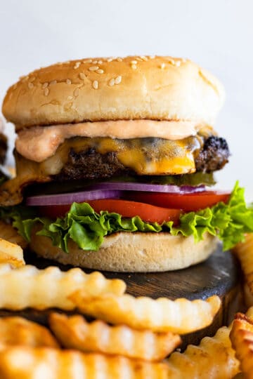 The classic burger piled high with toppings and burger sauce. Fries off to the side.