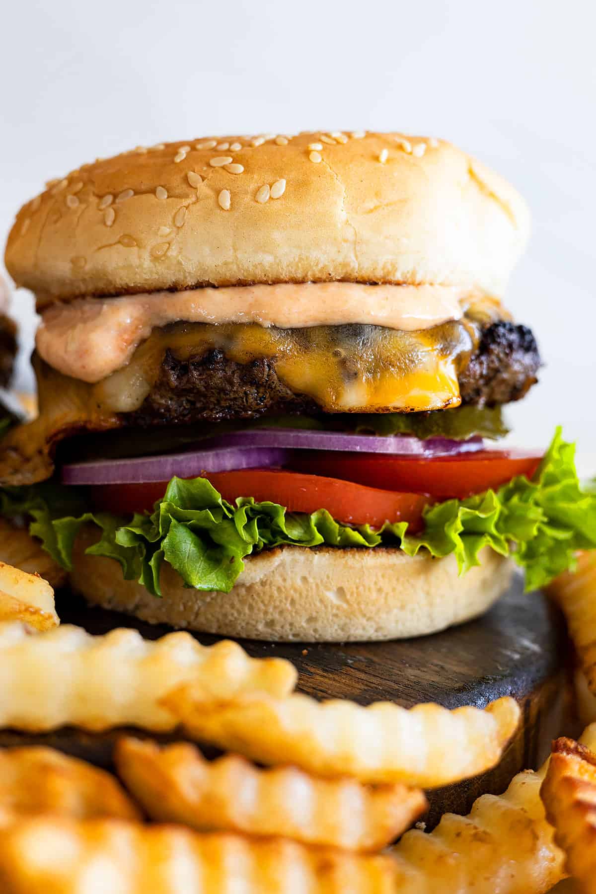 The classic burger piled high with toppings and burger sauce. Fries off to the side. 