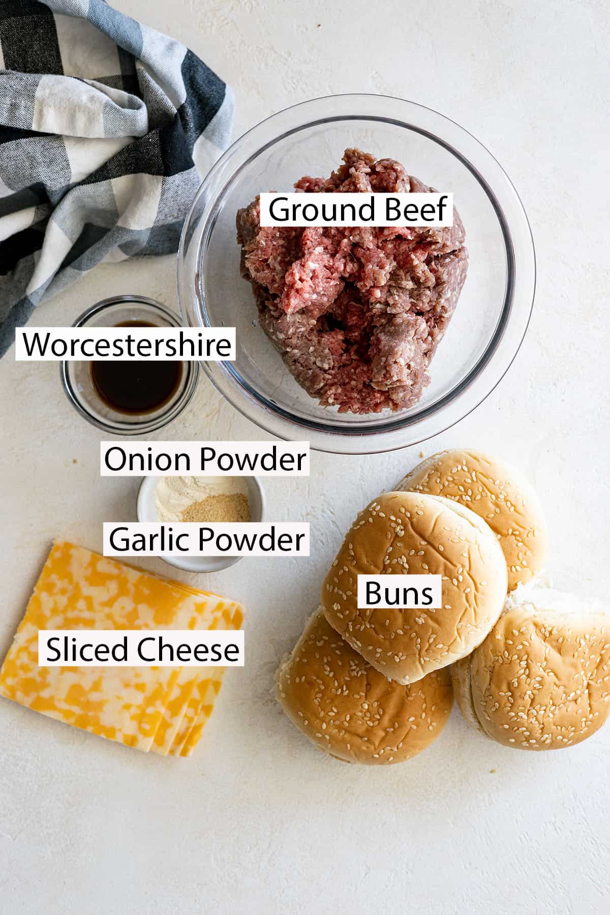 Burger ingredients: ground beef, buns, and optional garlic powder, onion powder, worcestershire, and sliced cheese. 