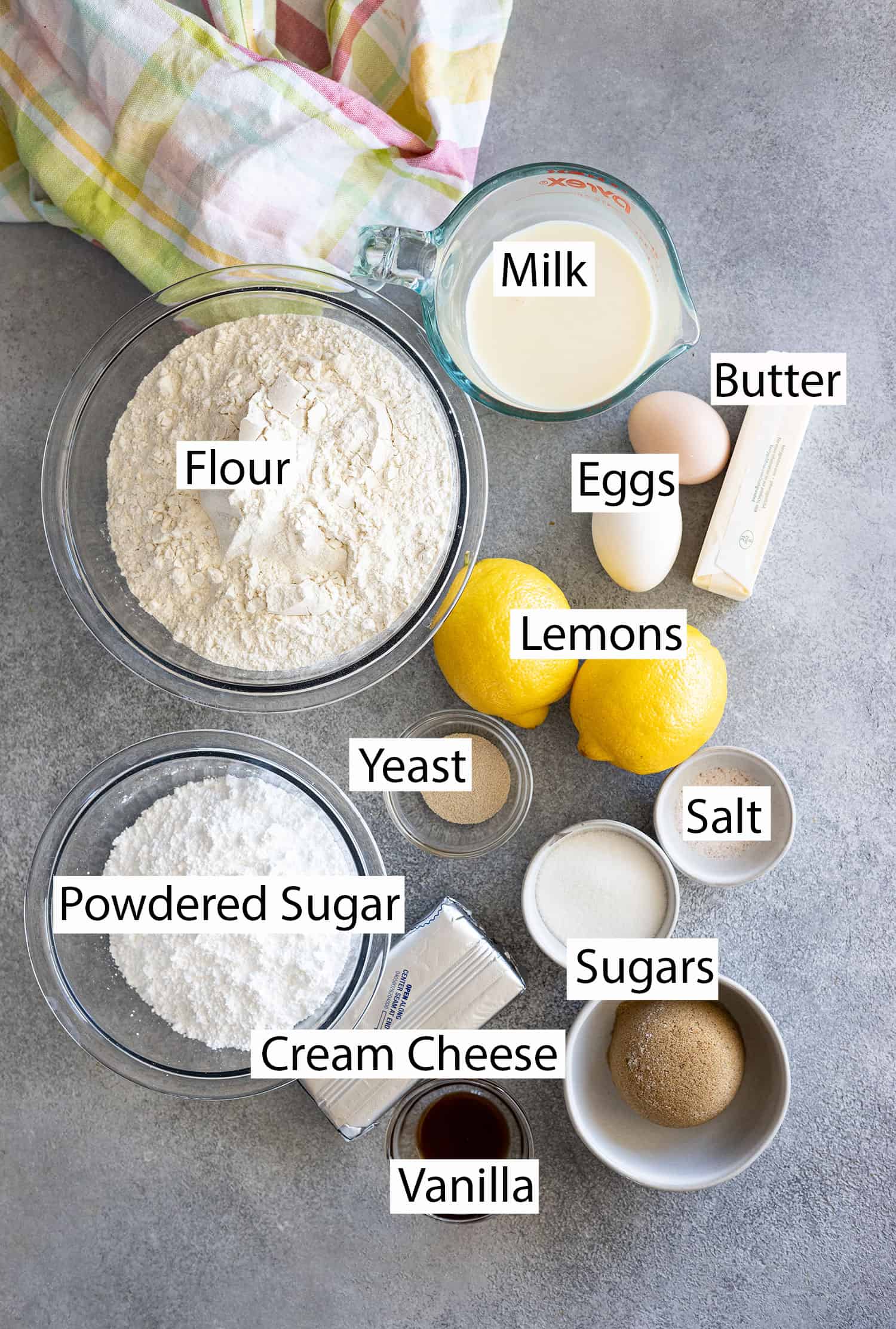 Ingredients: milk, butter, flour, eggs, lemons, yeast, salt, sugar, brown sugar, cream cheese, powdered sugar, and vanilla. 