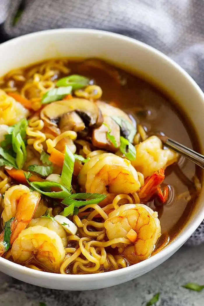 close up of ramen soup recipe in a bowl garnished with green onions