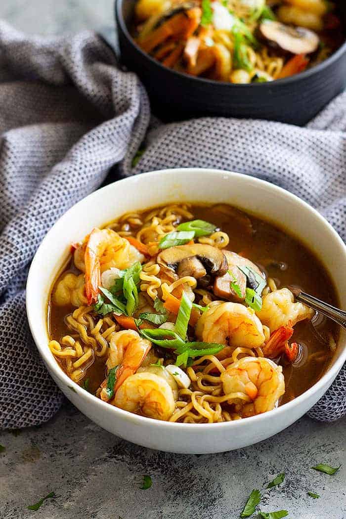 white bowl of shrimp ramen garnished with green onions