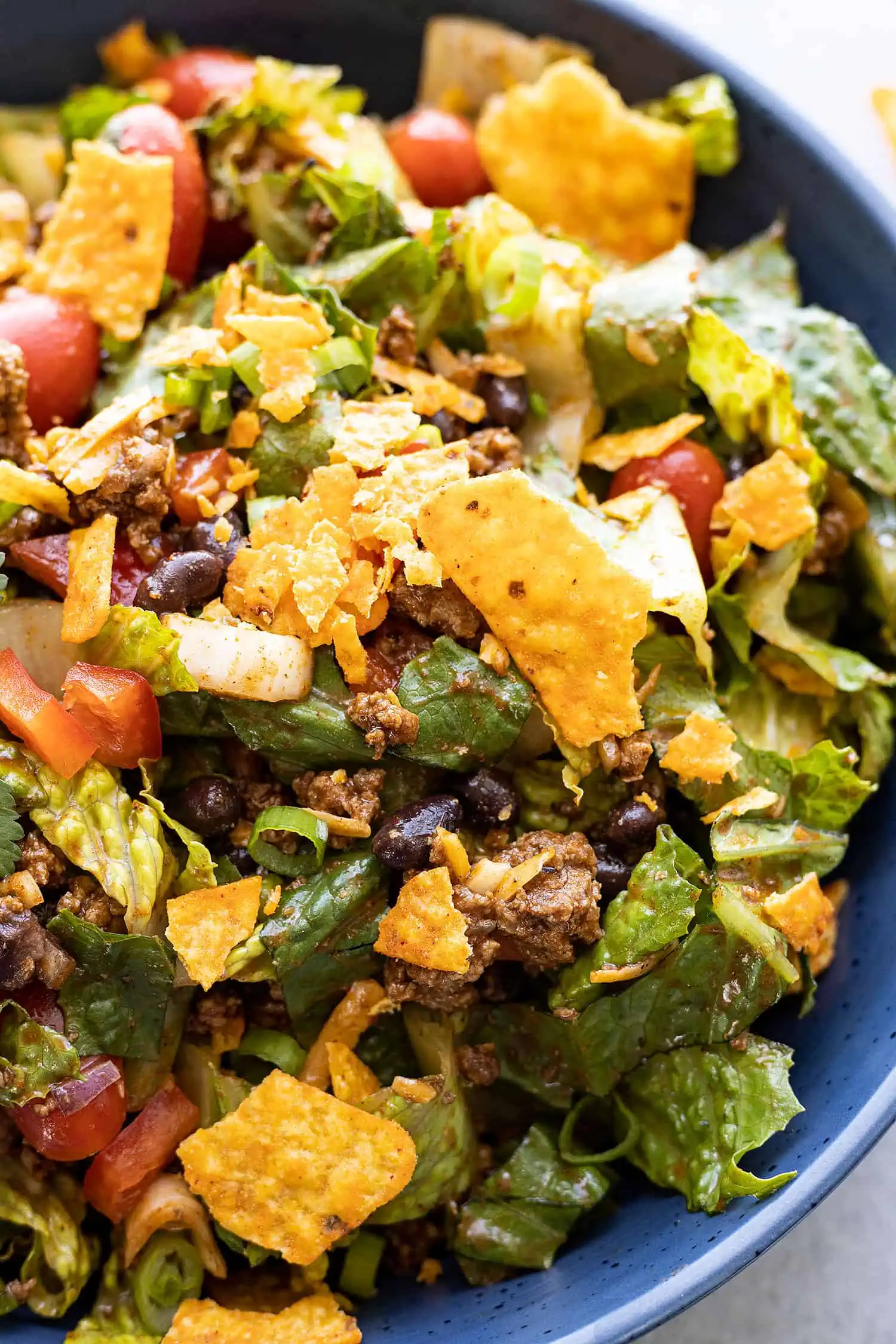 Close up of dorito taco salad in a blue bowl. 