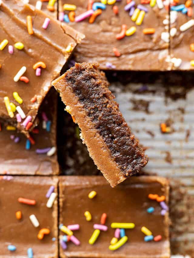 Overhead view of brownies cut with one turned on edge showing the brownie and the frosting.