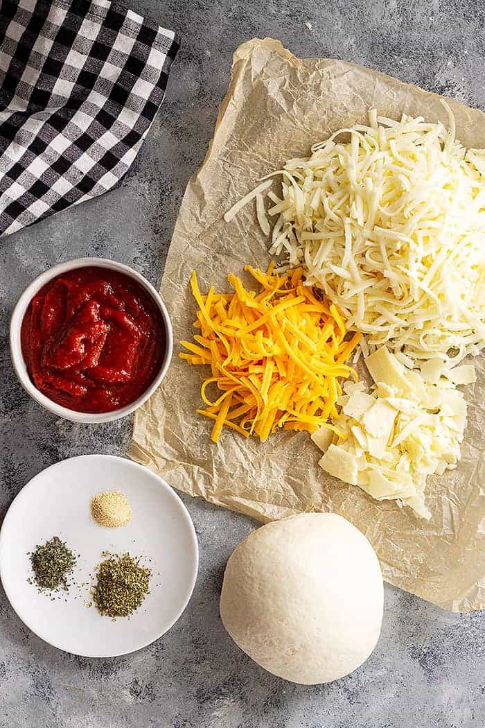 overhead: ingredients needed for cheesy pizza