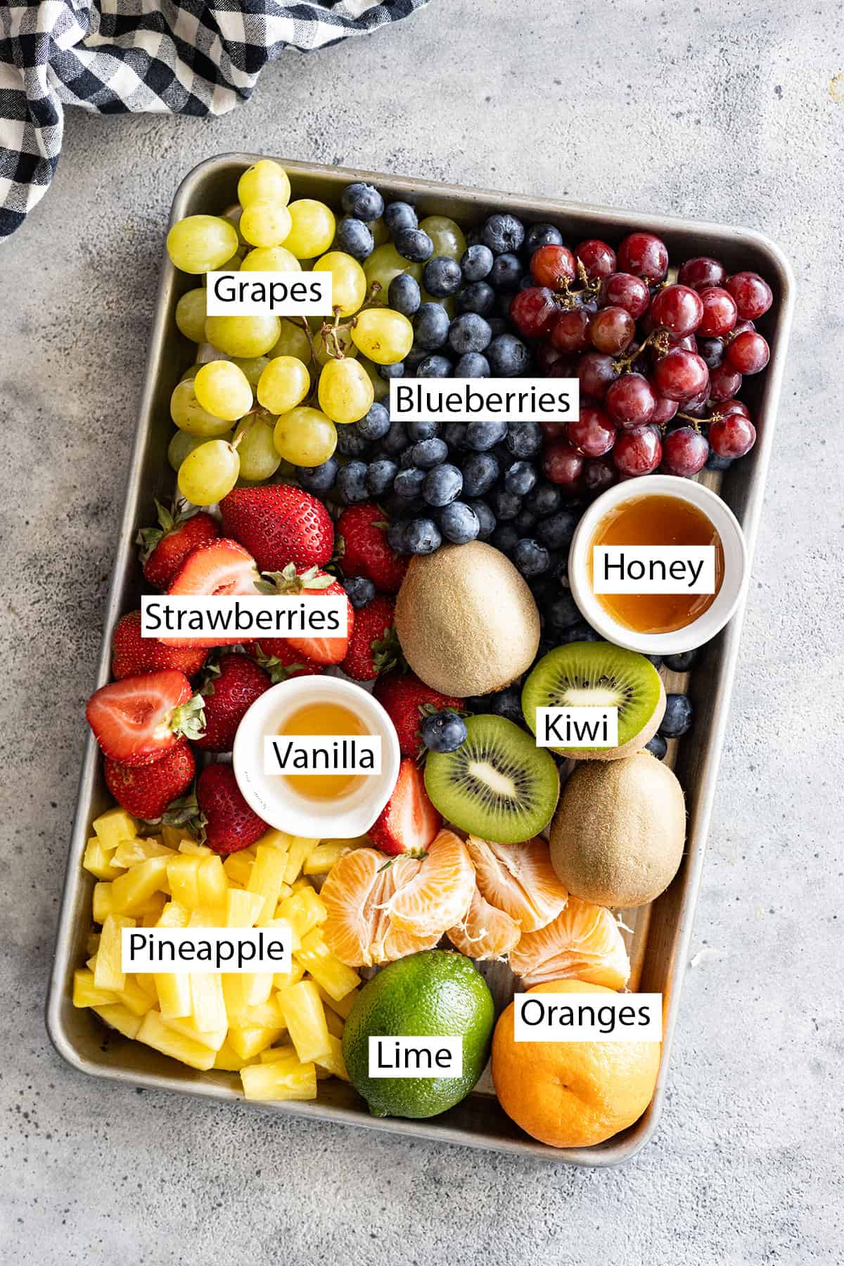 Ingredients: grapes, blueberries, strawberries, kiwi, oranges, pineapple, lime, honey, and vanilla.