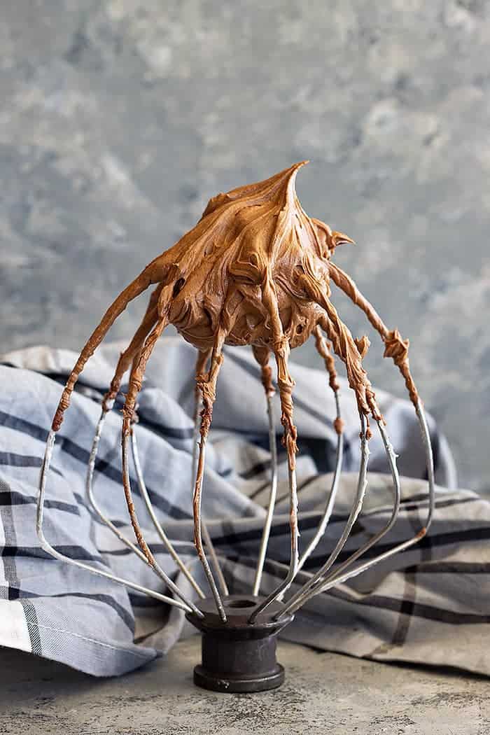 chocolate cream cheese frosting on a wire whisk