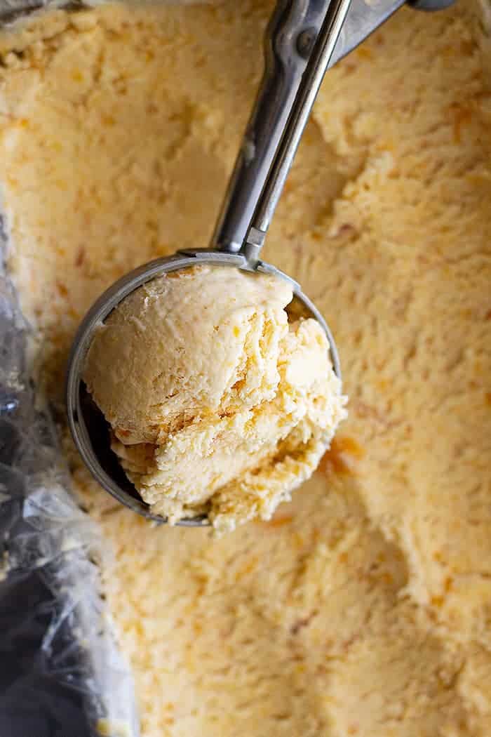 overhead: a scoop of homemade peach ice cream recipe