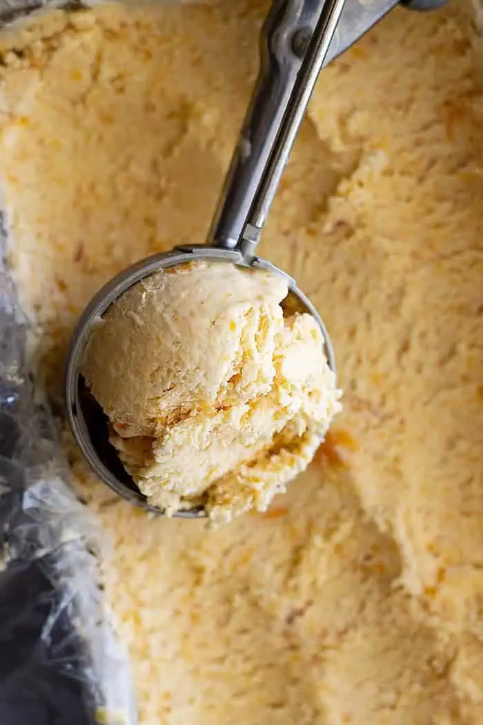 overhead: a scoop of homemade peach ice cream recipe