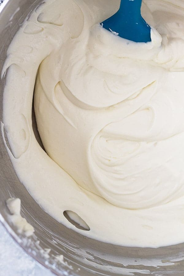 overhead: whipped cream folded into cream cheese with spatula