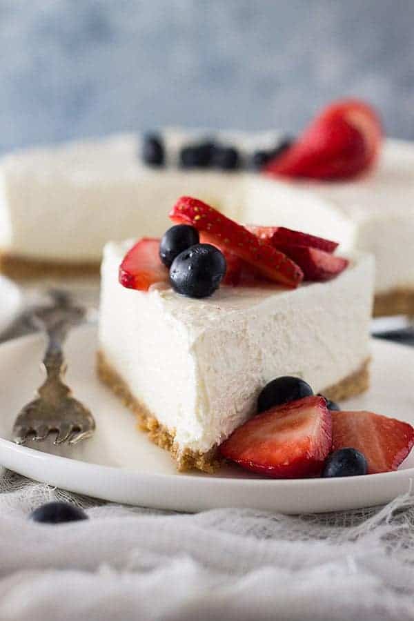 front view: slice of whipped cheesecake recipe topped with berries