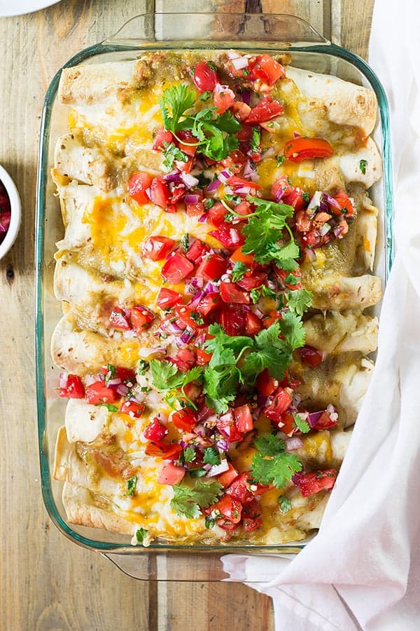 overhead: pan full of breakfast enchiladas recipe topped with pico de gallo