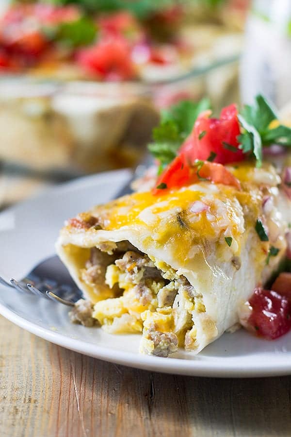 side view closeup: egg enchiladas full of sausage and scrambled eggs