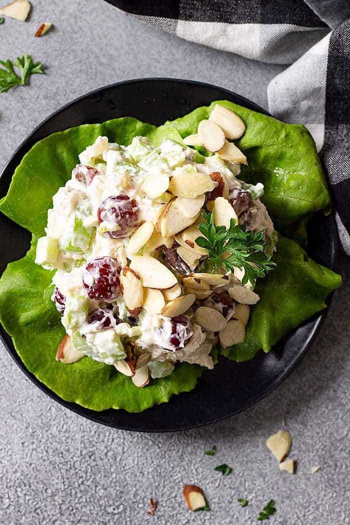 overhead of chicken salad on lettuce with sliced almonds