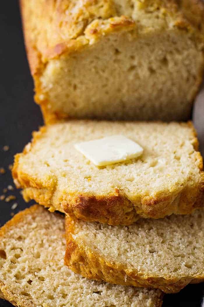 beer bread recipe cut into slices with a pat of butter 